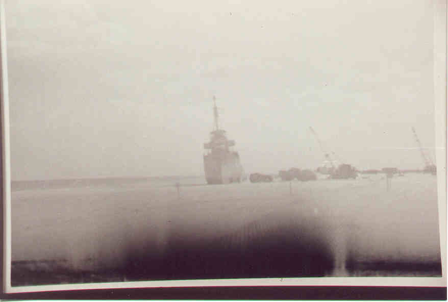 USS Monssen on beach and trucks